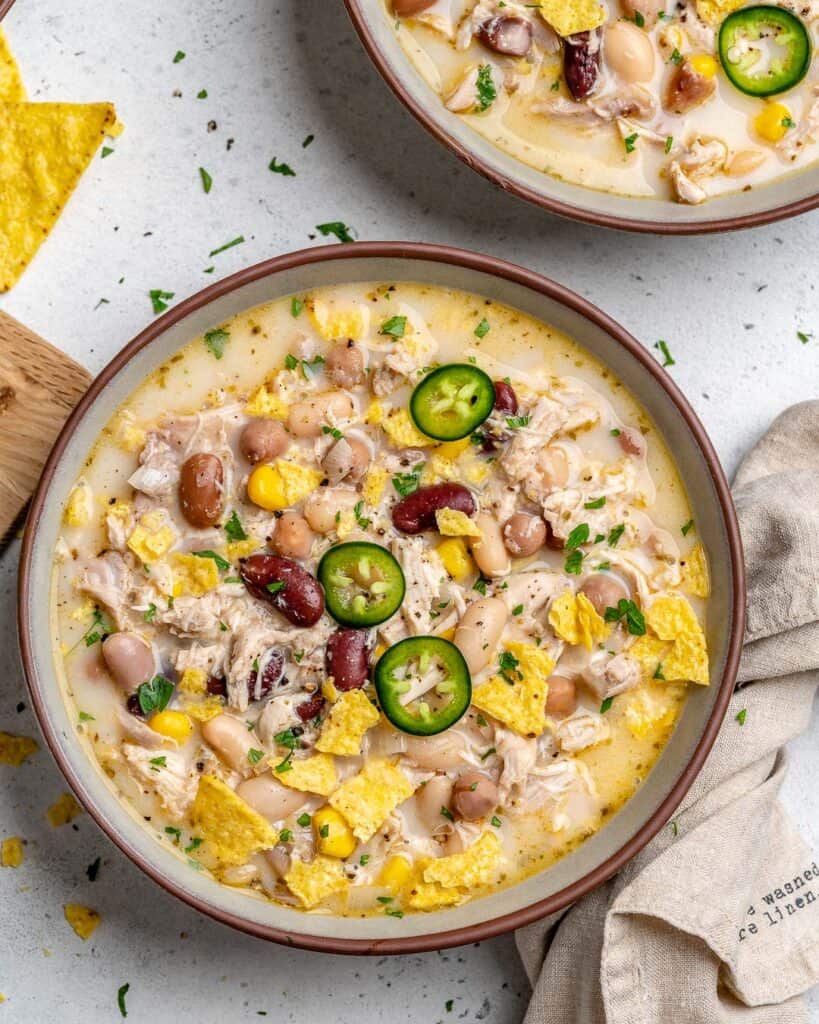 white chicken chili recipe in a round bowl made with 4 different beans
