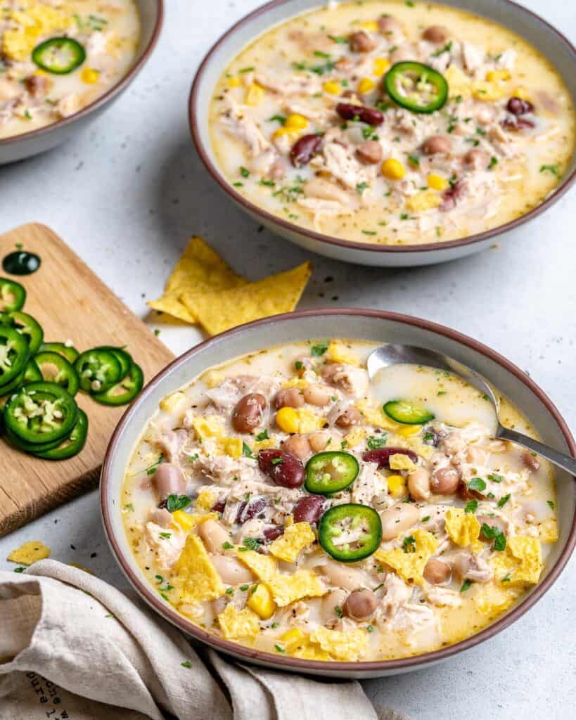 side shot of 2 round bowls with chicken chili 