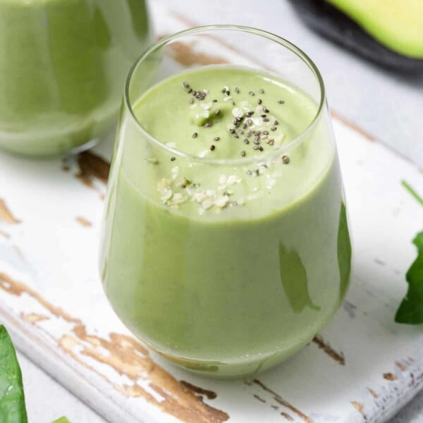 side shot of a cup with green avocado smoothie