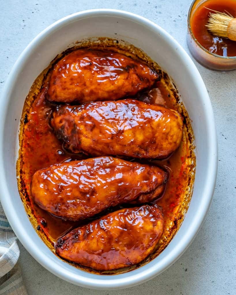 top view of 4 baked chicken breast in a white dish