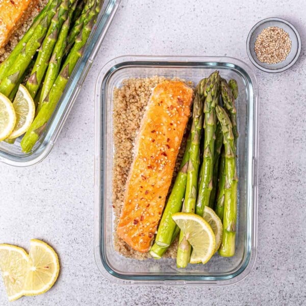 grilled salmon over quinoa with a side of grilled asparagus topped over quinoa.