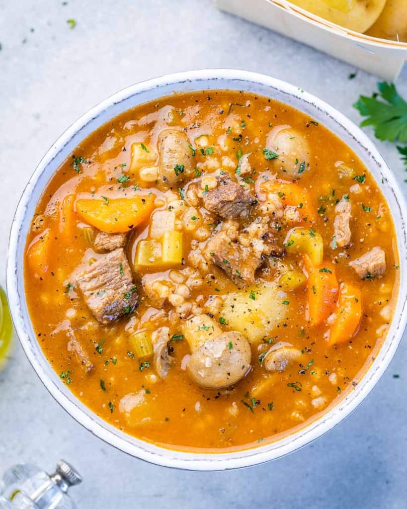 barley and beef soup in a white bowl