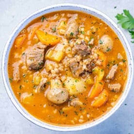 top view beef barley soup in a white bowll