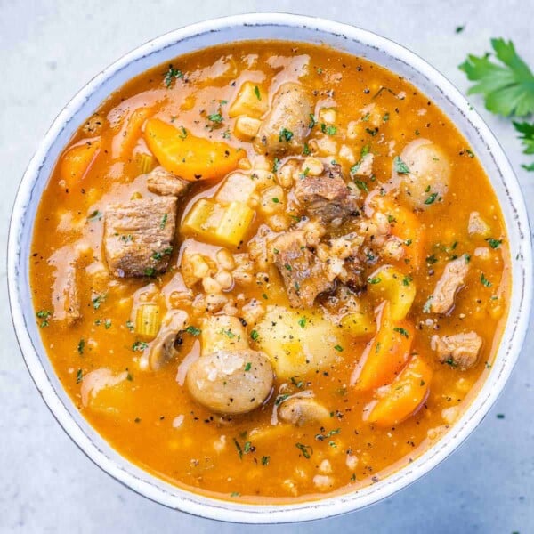 top view beef barley soup in a white bowll
