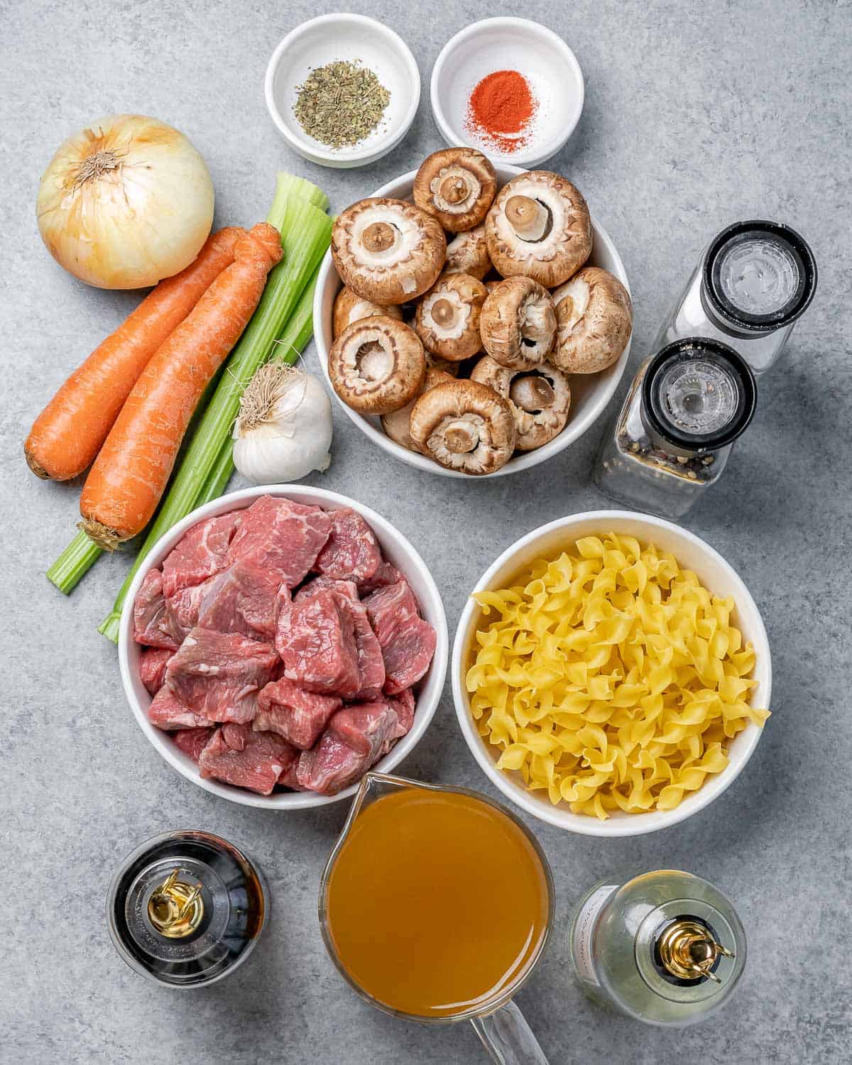 Beef, mushrooms, pasta, broth, onion, carrots and celery divided into small portions.