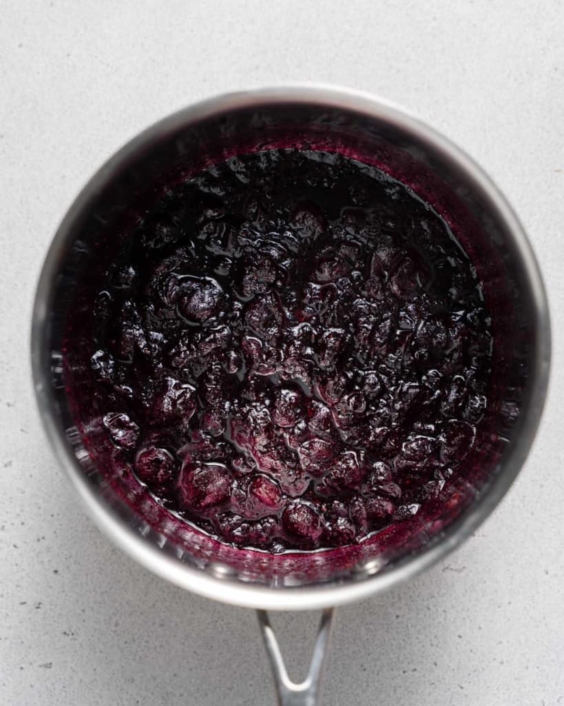 Cooked blueberries in a saucepan.