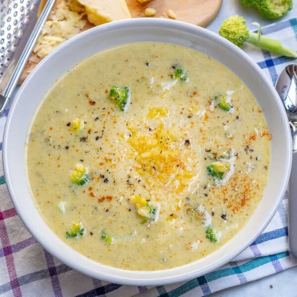 top view of a bowl of Broccoli Soup recipe over a colorful towel.