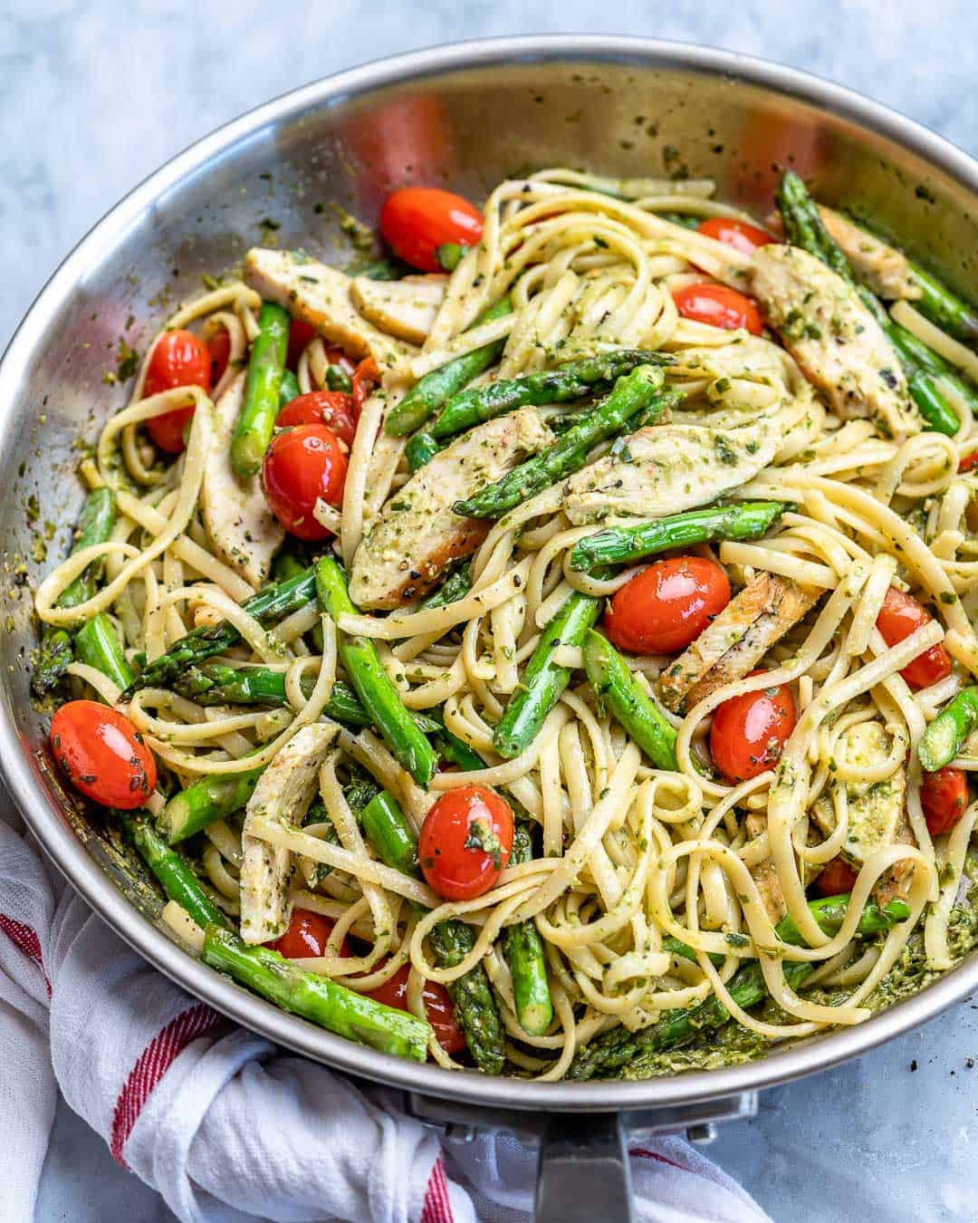 side shot of asparagus chicken pasta in a pan 