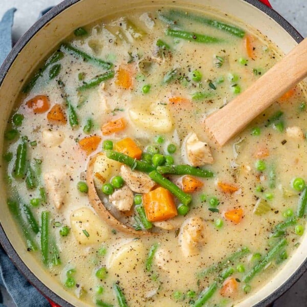 top view chicken and gnocchi soup in a red pot