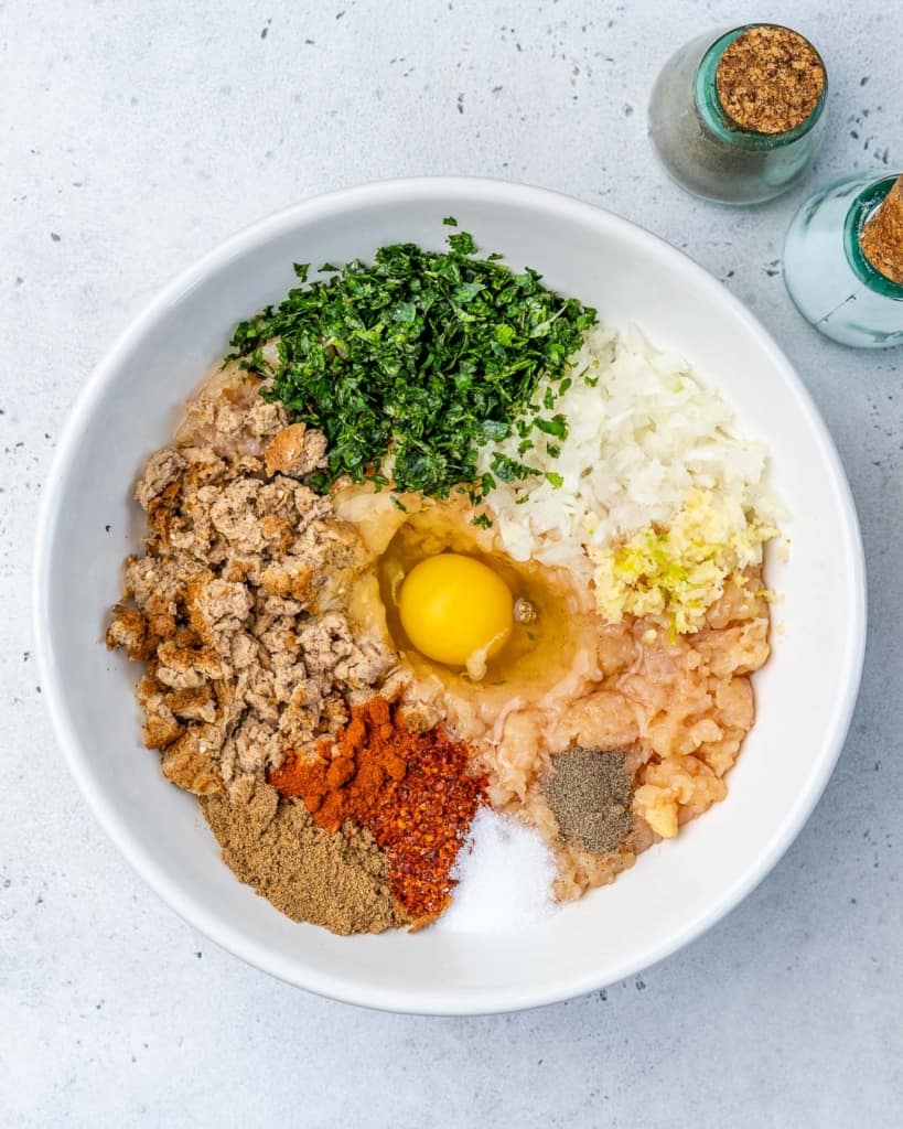 all chicken kafta ingredients in a white bowl before mixing 