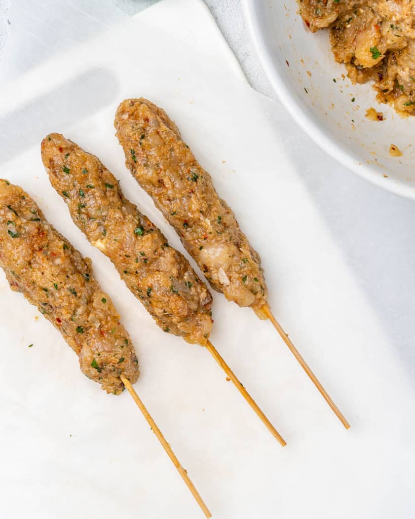 chicken kafta logs on skewers before grilling 