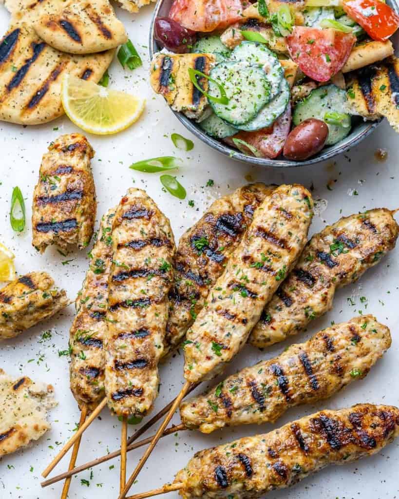 side shot of chicken kafta kebab next to salad bowl