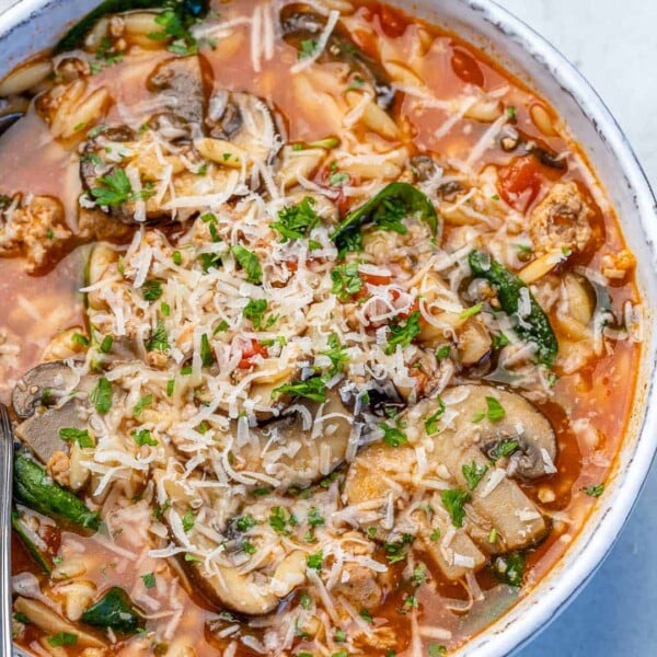 top view chicken orzo soup in a white bowl