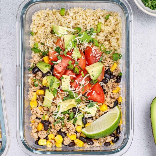 top view glass bowl of meal pre ground chicken taco with quinoa and beans
