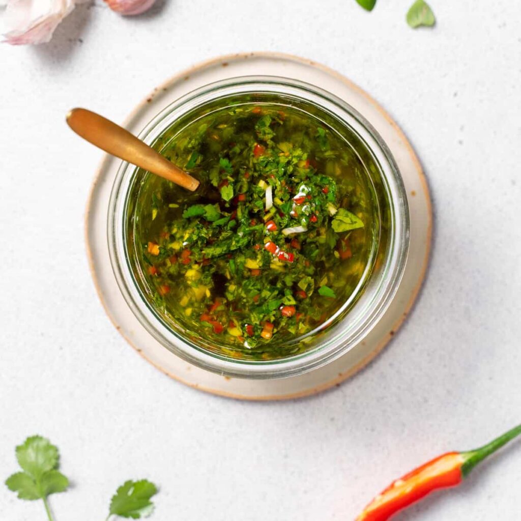 top view of a jar full of chimichurri sauce 