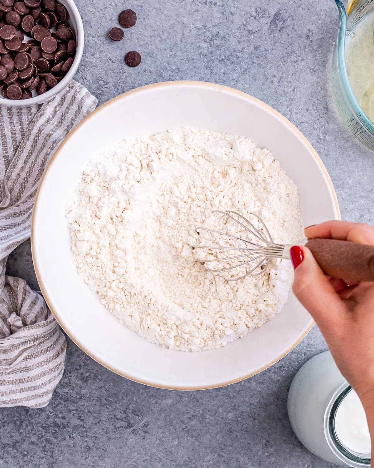 Whisking flour with baking powder, baking soda and salt.