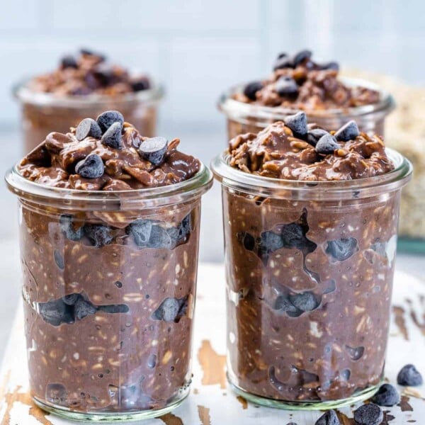 Four jars of chocolate overnight oats with chocolate chips.