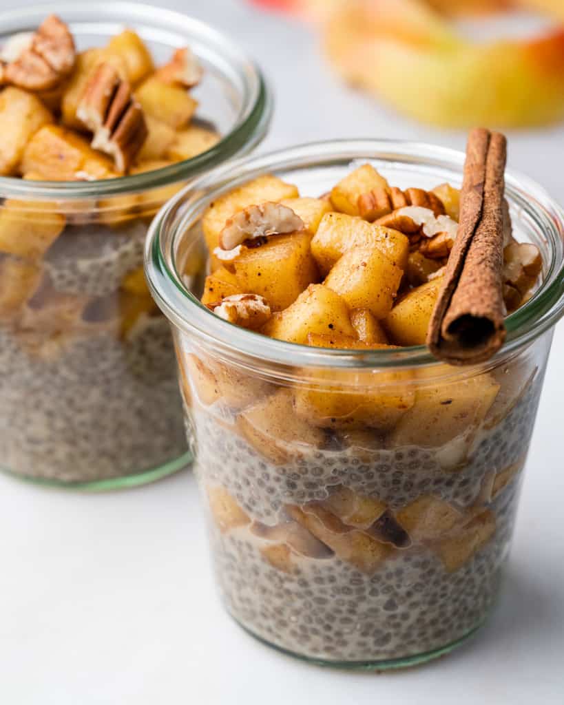 side shot of apple pia chia pudding in a jar topped with apple pie mix