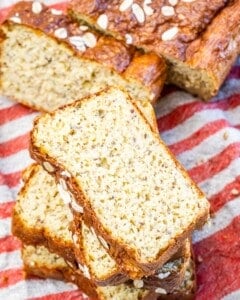 slices of fresh baked bread over a red and white towel.