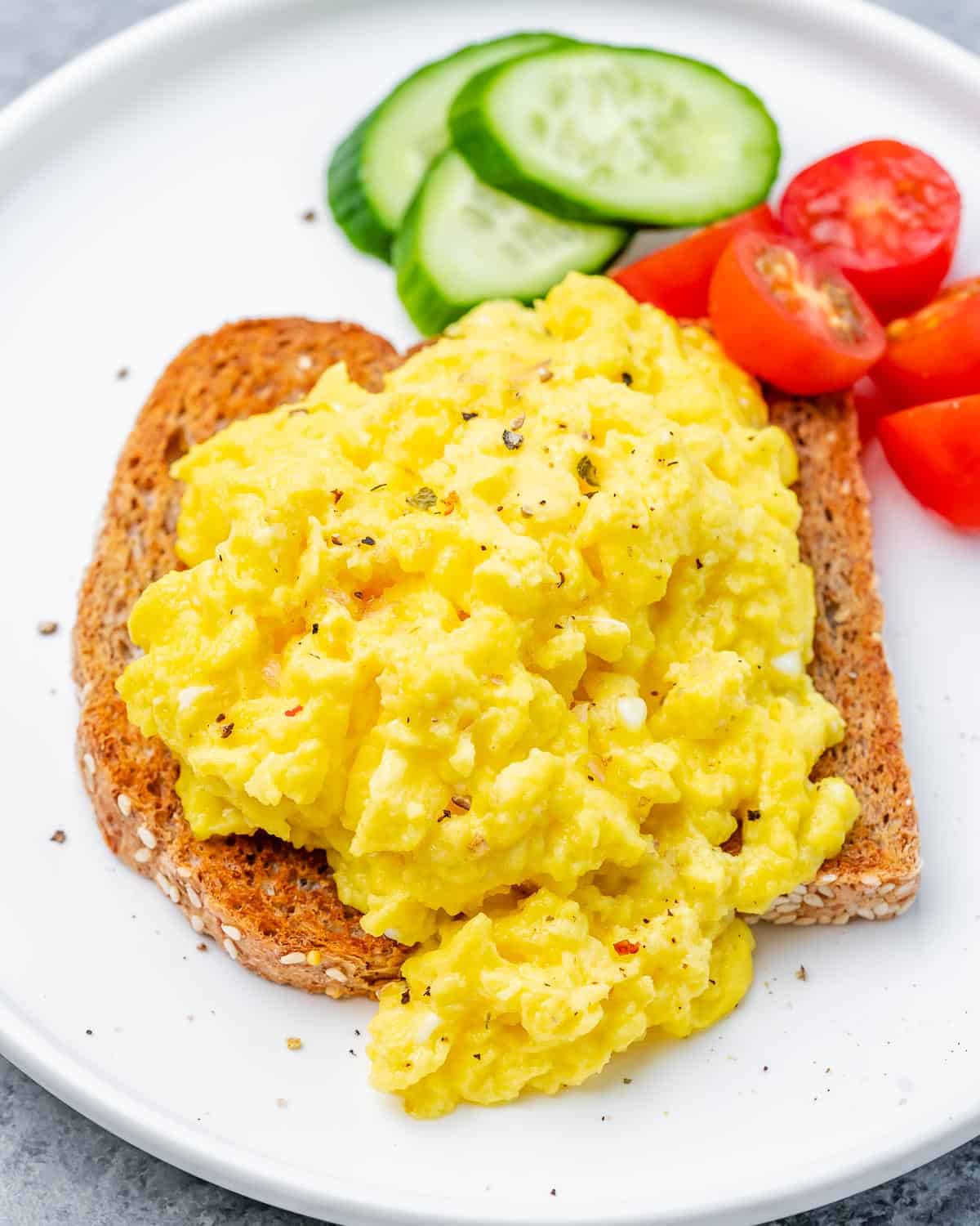 Cottage cheese eggs served on toast with a side of fresh veggies.