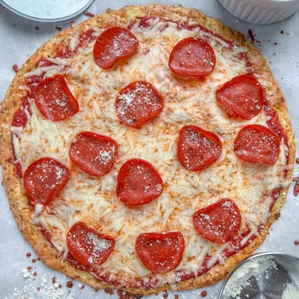 a round pizza crust topped with melted cheese and pepperoni.