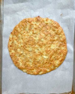 baked cottage cheese pizza crust on a pan.