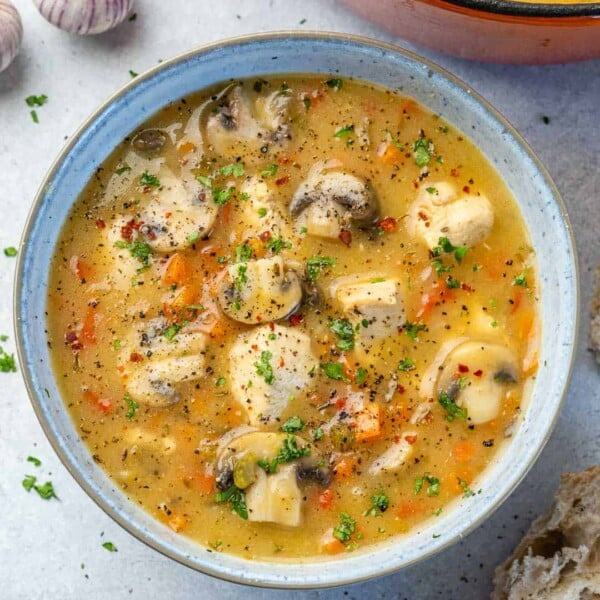 top view chicken soup in white rustic bowl