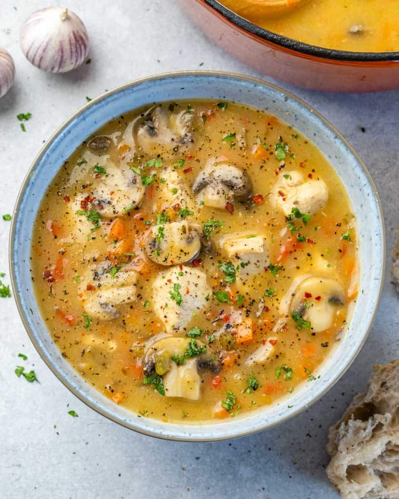 top view chicken soup in white rustic bowl