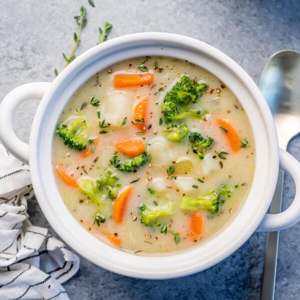 top view of a white round bowl of creamy vegetable soup