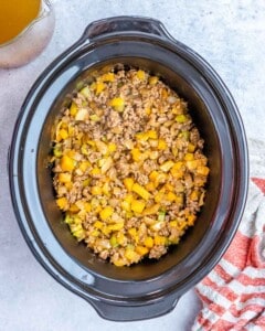 Sauteed browned meat and veggies are added to the crockpot.
