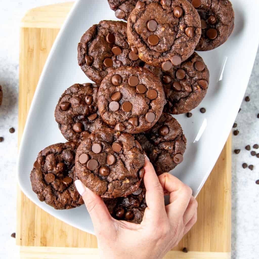 hand reaching for chocolate chip muffins 