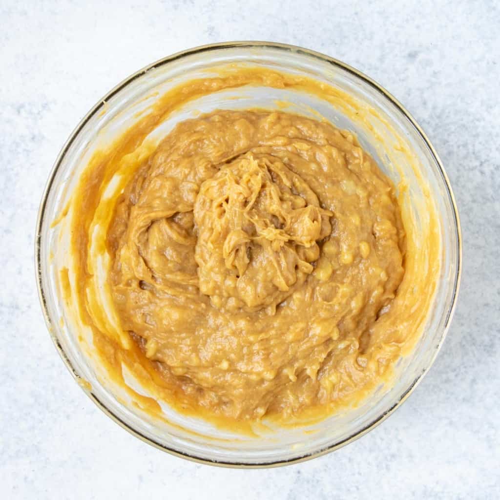 banana peanut butter and eggs combined in a bowl