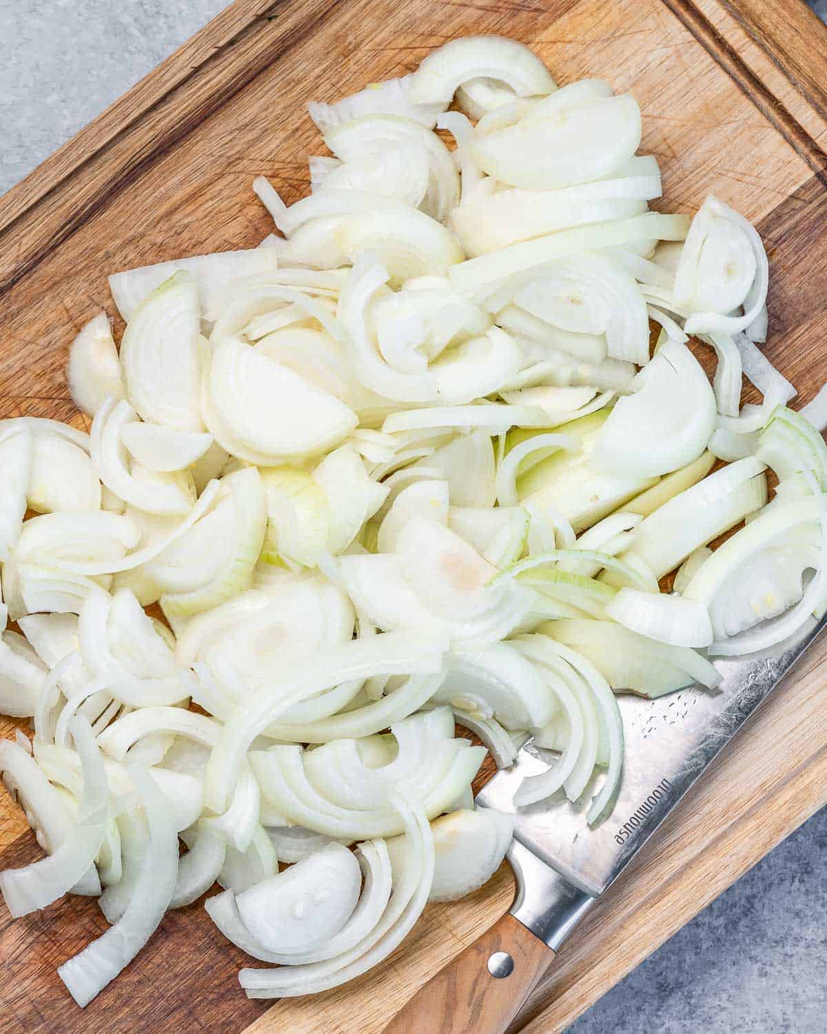 Chopped onion on a cutting board.