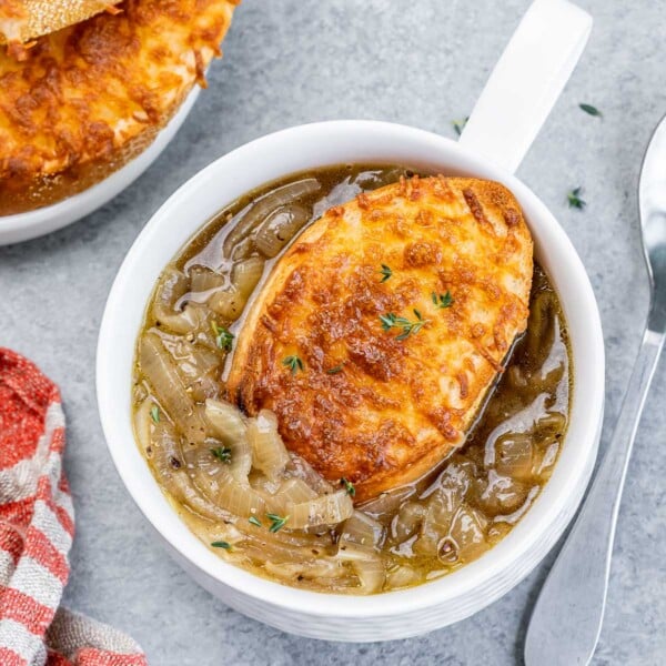 top view of a small bowl of french onion soup topped with cheesy toast over the soup