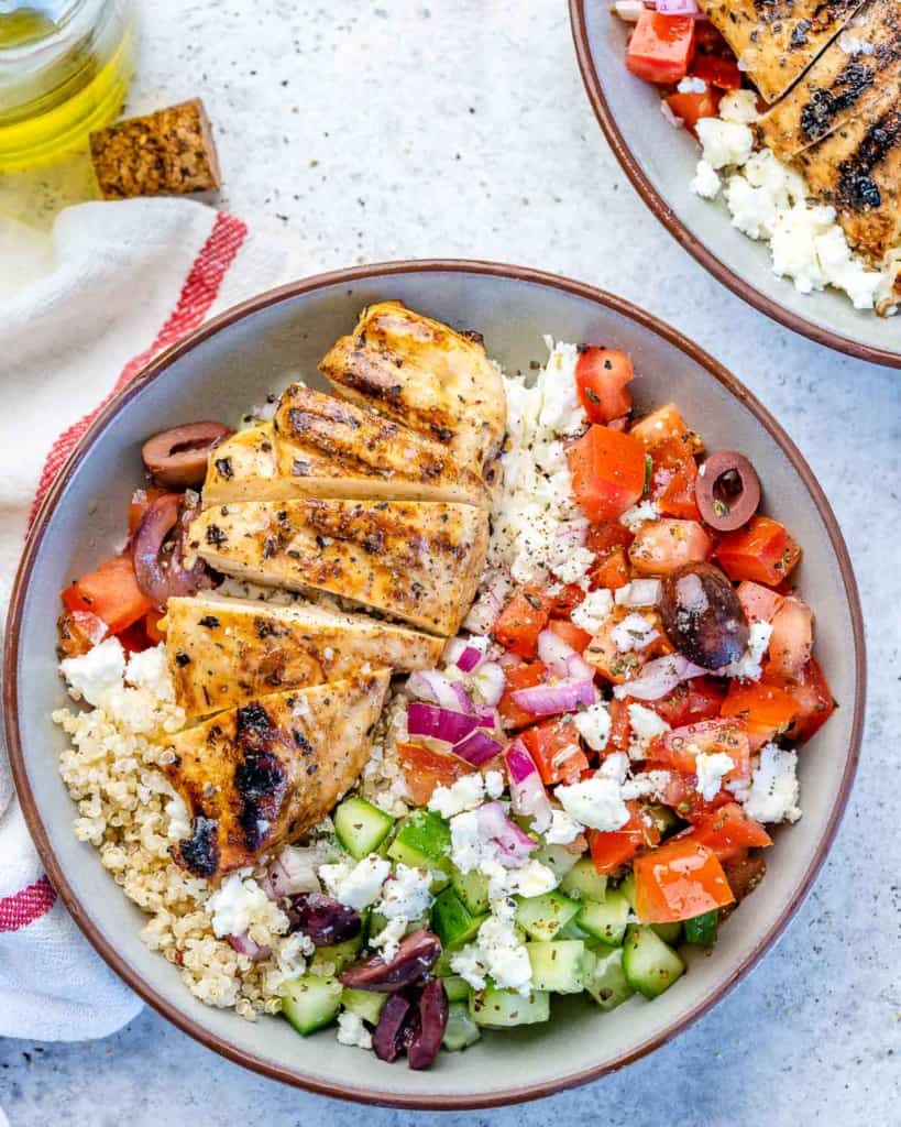 One bowl filled with Greek chicken and vegetables