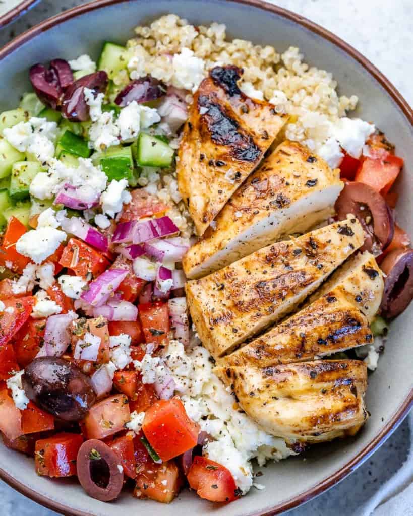 Sliced chicken on top of Greek chicken bowl