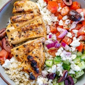 Close image of Greek chicken bowl with veggies