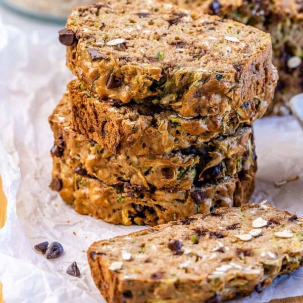 stacks of zucchini bread slices on a parchment paper.