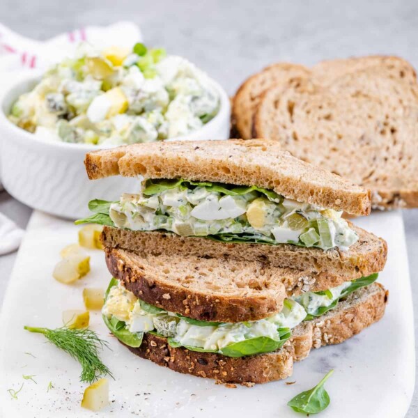 side shot of egg salad sandwich on a plate