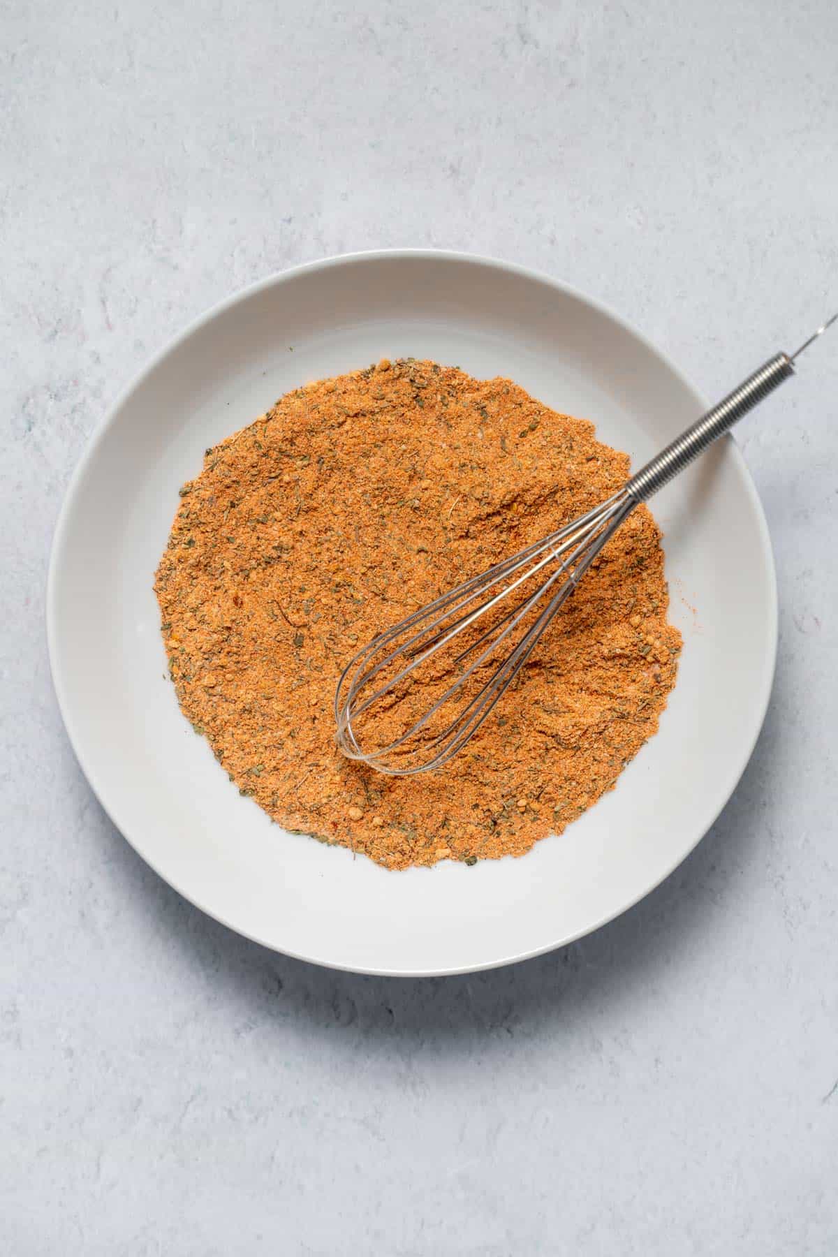 bowl of cajun seasoning with whisk