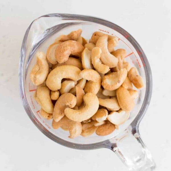 roasted cashews in a measuring cup