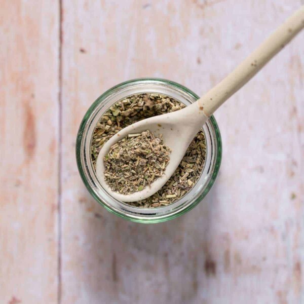 poultry seasoning in a jar with spoon over it