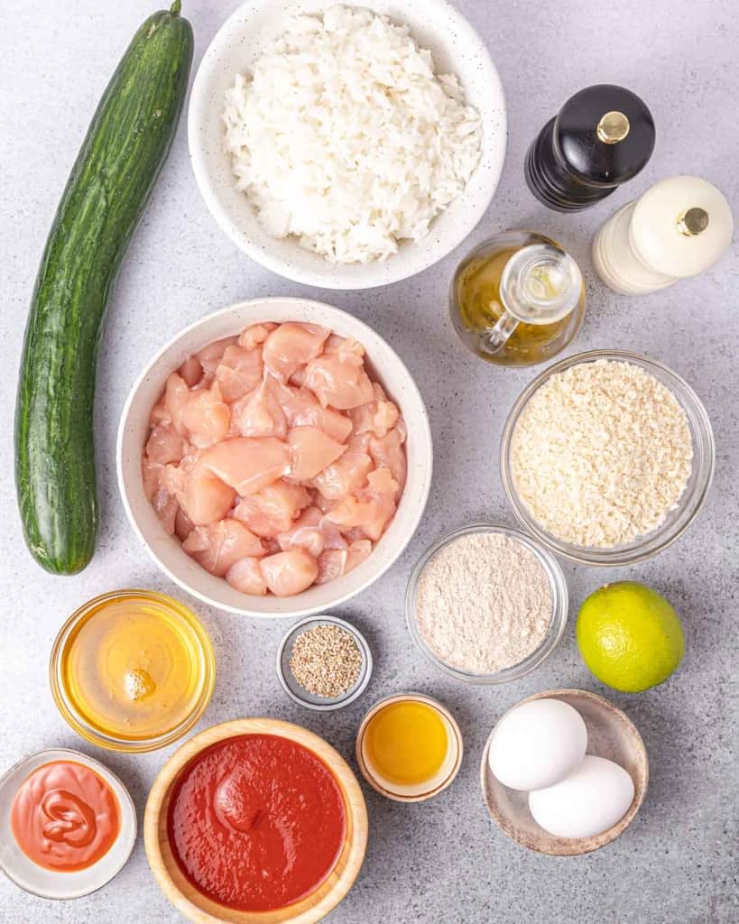 Uncooked chicken and other ingredients portioned into smaller bowls.