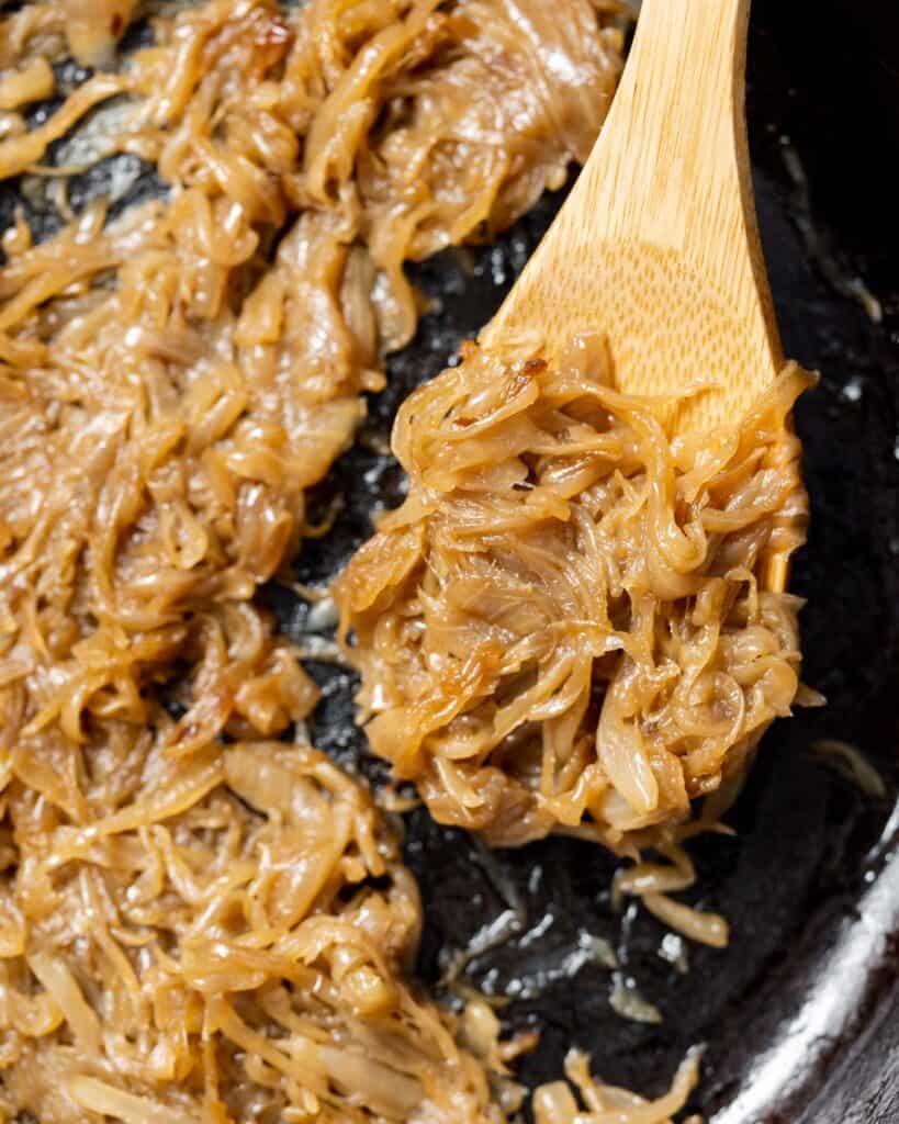 spoonful of caramelized onions over a skillet