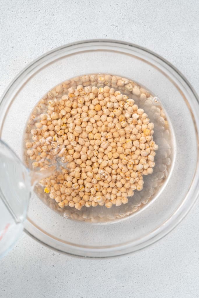Covering chickpeas with water.