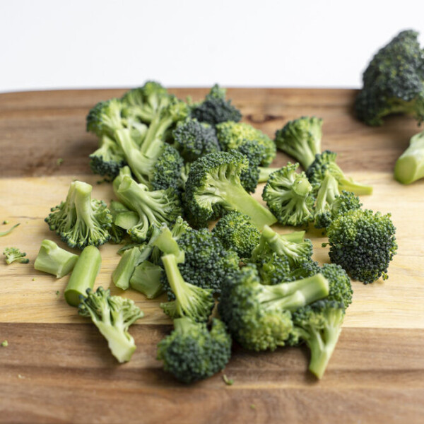 chopped broccoli florets on a cutting board for a how to cut broccoli into florets tutorial