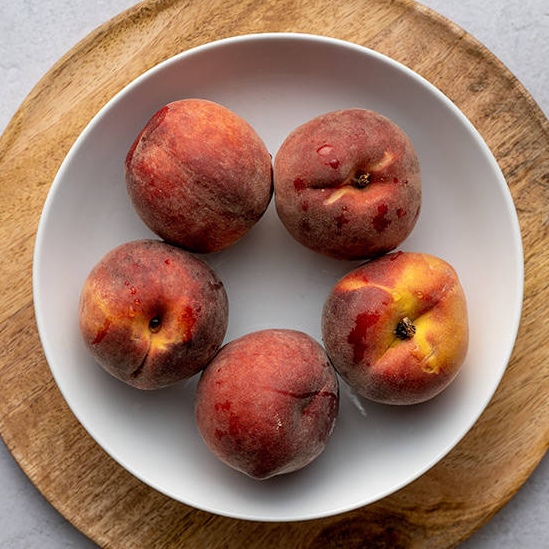 top view of plate with 5 peaches
