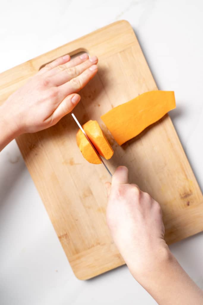 Slicing a sweet potato from the top.