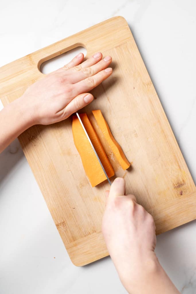 Slicing sweet potato into sticks.