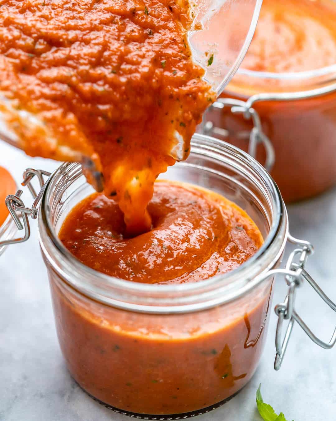 marinara sauce being poured in jar
